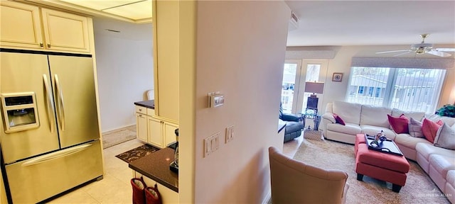 living area with a ceiling fan and visible vents