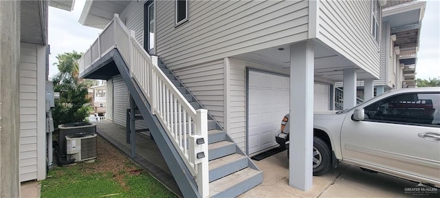 doorway to property with a garage and cooling unit