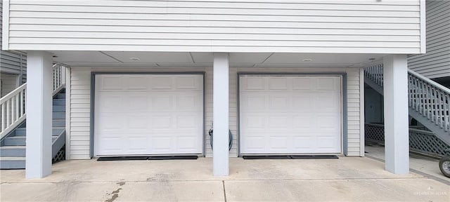 garage featuring concrete driveway