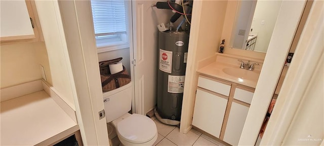 bathroom with water heater, vanity, toilet, and tile patterned floors