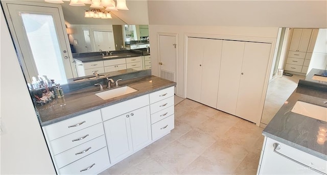 kitchen featuring white cabinets and a sink