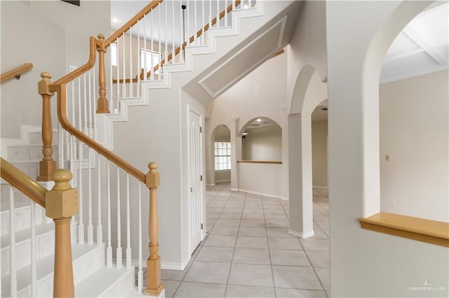 1711 Solar Dr, Mission, TX 78574 - foyer featuring arched walkways, light tile patterned flooring, baseboards, and stairs