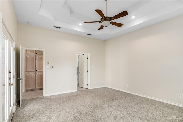 1711 Solar Dr, Mission, TX 78574 - unfurnished bedroom featuring light carpet, recessed lighting, a tray ceiling, baseboards, and a ceiling fan