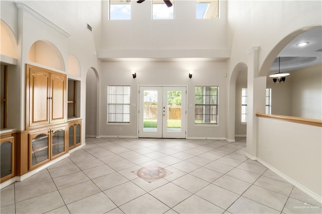 1711 Solar Dr, Mission, TX 78574 - unfurnished living room with a high ceiling, ceiling fan, plenty of natural light, and light tile patterned floors