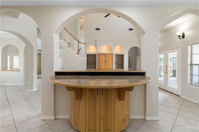 1711 Solar Dr, Mission, TX 78574 - kitchen with light tile patterned flooring, a breakfast bar area, lofted ceiling, baseboards, and open shelves