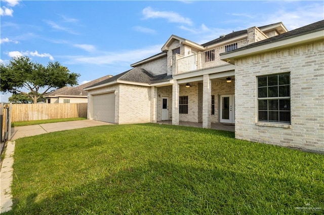 1711 Solar Dr, Mission, TX 78574 - rear view of property with concrete driveway, a balcony, an attached garage, a patio area, and brick siding