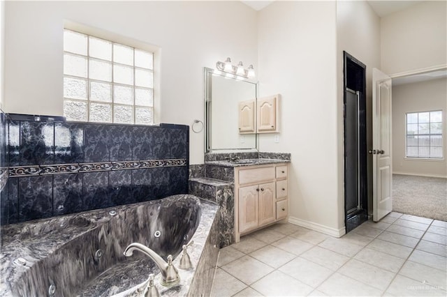 1711 Solar Dr, Mission, TX 78574 - bathroom featuring tile patterned flooring, a jetted tub, vanity, and baseboards