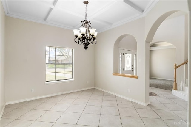 1711 Solar Dr, Mission, TX 78574 - empty room with a chandelier, coffered ceiling, light tile patterned floors, beamed ceiling, and arched walkways