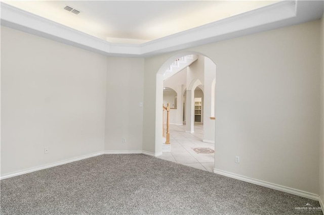 1711 Solar Dr, Mission, TX 78574 - spare room with light colored carpet, arched walkways, baseboards, and a raised ceiling