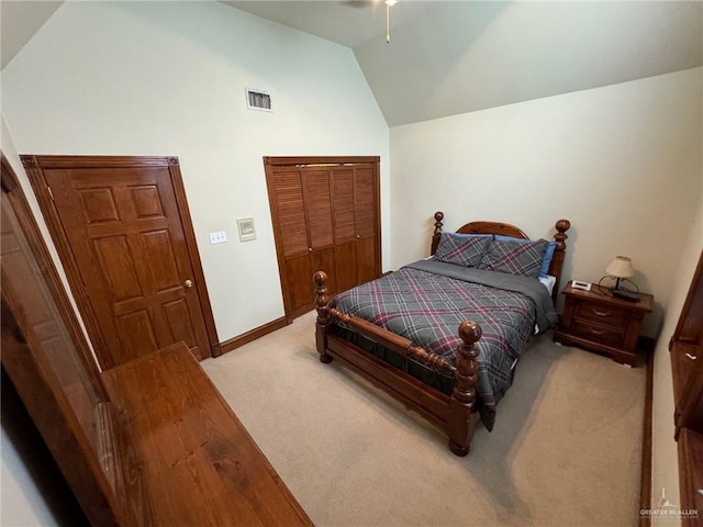 carpeted bedroom featuring ceiling fan, lofted ceiling, and a closet