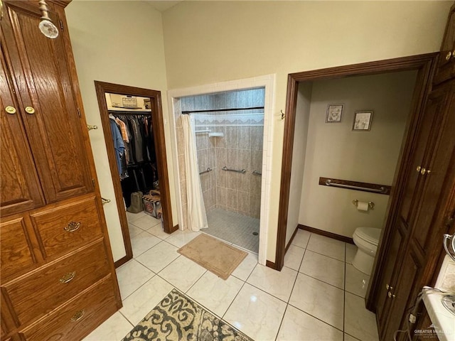 bathroom with toilet, tile patterned flooring, and a shower with shower curtain