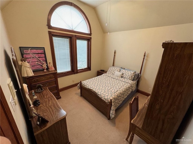 bedroom with lofted ceiling and light colored carpet