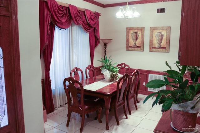 dining space featuring a notable chandelier, light tile patterned floors, a wealth of natural light, and ornamental molding