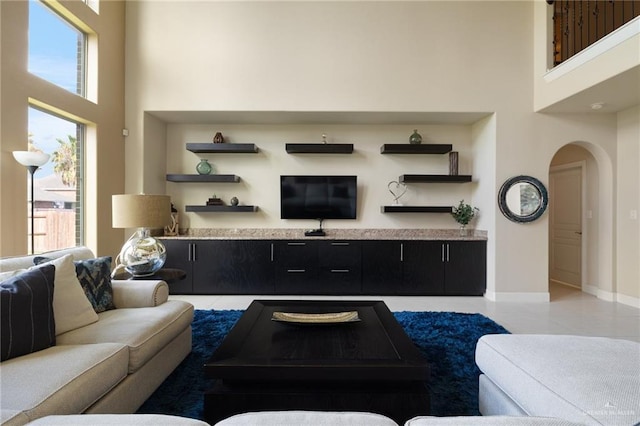 3502 Plantation Grove Blvd, Mission, TX 78572 - living room with arched walkways, a towering ceiling, healthy amount of natural light, and light tile patterned floors