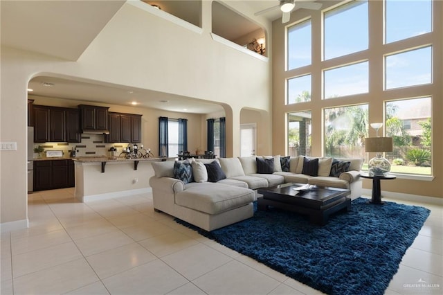 3502 Plantation Grove Blvd, Mission, TX 78572 - living area featuring arched walkways, light tile patterned flooring, and a towering ceiling