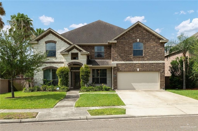 3502 Plantation Grove Blvd, Mission, TX 78572 - view of front of home featuring an attached garage, brick siding, driveway, and stone siding