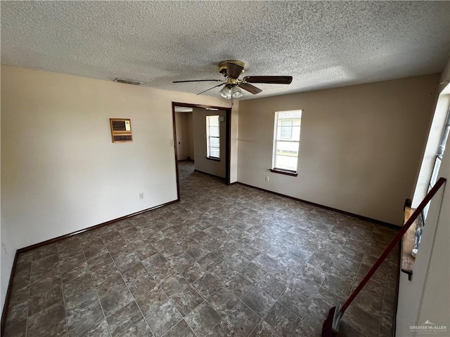 spare room featuring ceiling fan and a textured ceiling