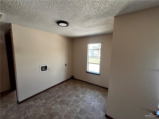 spare room with a textured ceiling