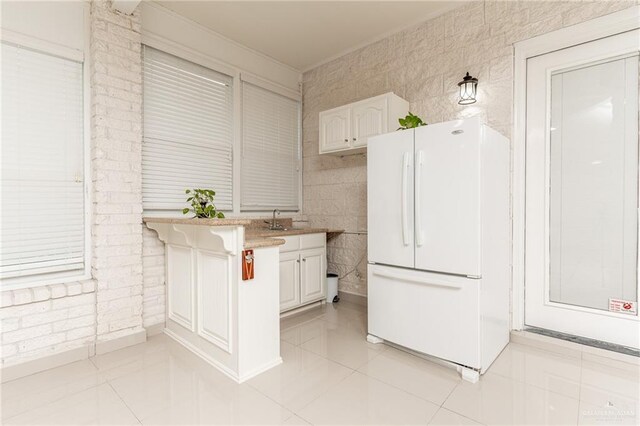 5501 N 8th St, Mcallen, TX 78504 - kitchen featuring white cabinets, freestanding refrigerator, a sink, and light tile patterned floors
