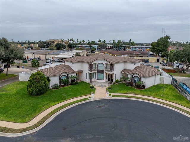 5501 N 8th St, Mcallen, TX 78504 - mediterranean / spanish house featuring a residential view, a tile roof, a front lawn, and fence