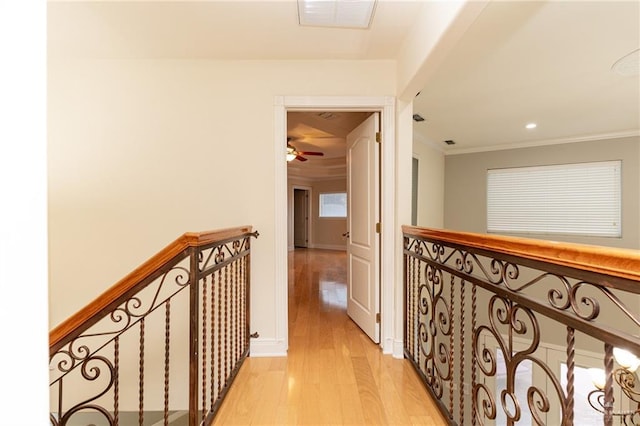 5501 N 8th St, Mcallen, TX 78504 - hall with crown molding, visible vents, light wood finished floors, and an upstairs landing