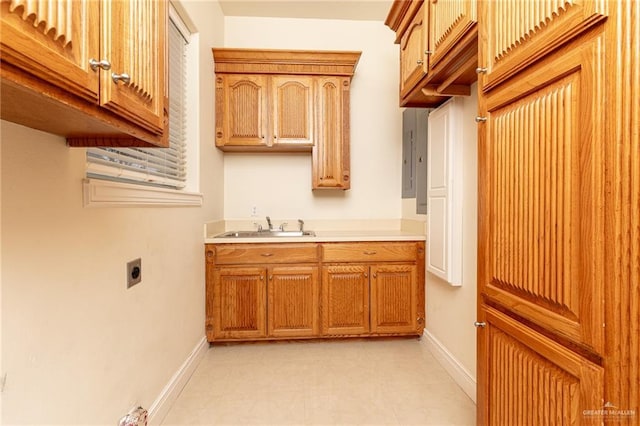 5501 N 8th St, Mcallen, TX 78504 - laundry area with baseboards, a sink, hookup for an electric dryer, and cabinet space