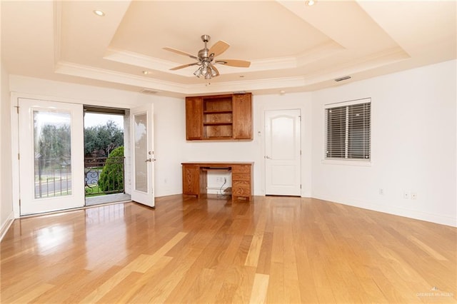 5501 N 8th St, Mcallen, TX 78504 - unfurnished living room with light wood finished floors, a tray ceiling, baseboards, a ceiling fan, and crown molding