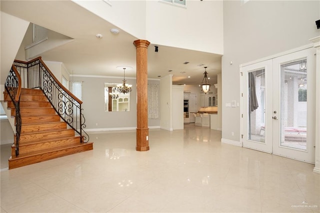 5501 N 8th St, Mcallen, TX 78504 - unfurnished living room featuring ornate columns, french doors, baseboards, a chandelier, and stairs