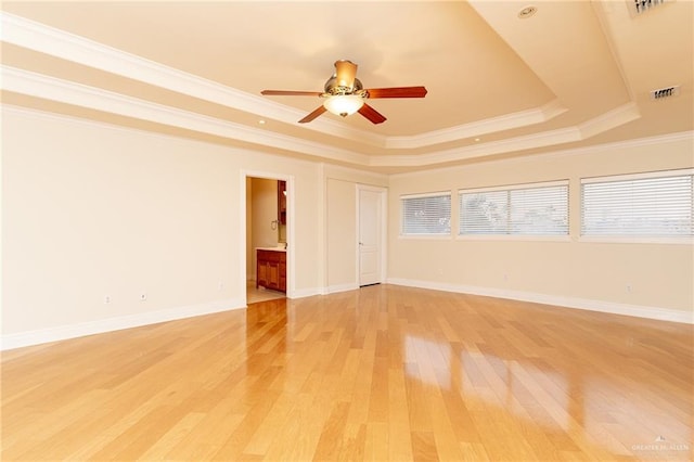 5501 N 8th St, Mcallen, TX 78504 - empty room featuring light wood-type flooring, visible vents, a ceiling fan, ornamental molding, and a raised ceiling