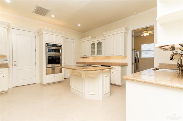 5501 N 8th St, Mcallen, TX 78504 - kitchen featuring a sink, a warming drawer, white cabinets, appliances with stainless steel finishes, and visible vents