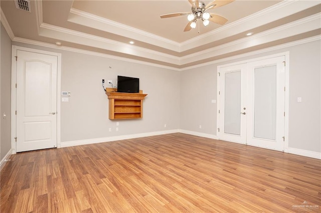 5501 N 8th St, Mcallen, TX 78504 - unfurnished living room with a raised ceiling, visible vents, french doors, light wood-style flooring, and ceiling fan