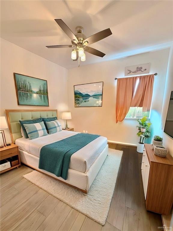 bedroom with wood-type flooring and ceiling fan