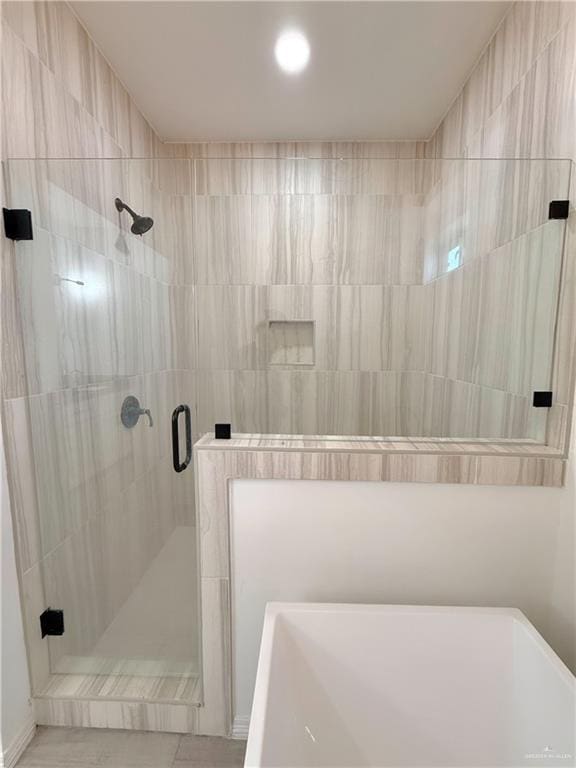 bathroom with separate shower and tub