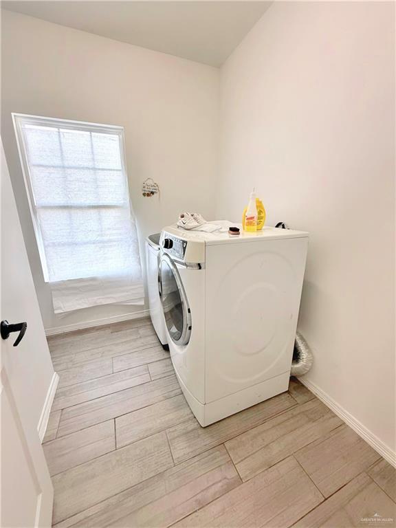 laundry room with washing machine and clothes dryer