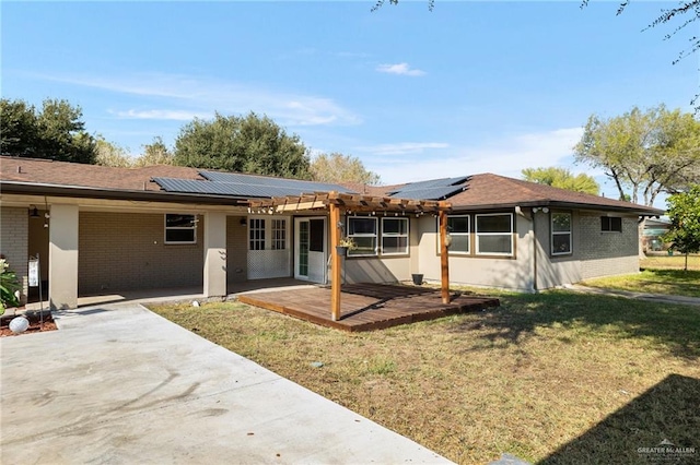 1500 N Bryan Rd, Mission, TX 78572 - back of house featuring brick siding, a patio, a yard, and roof mounted solar panels