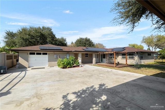1500 N Bryan Rd, Mission, TX 78572 - ranch-style home with a garage, driveway, brick siding, and roof mounted solar panels