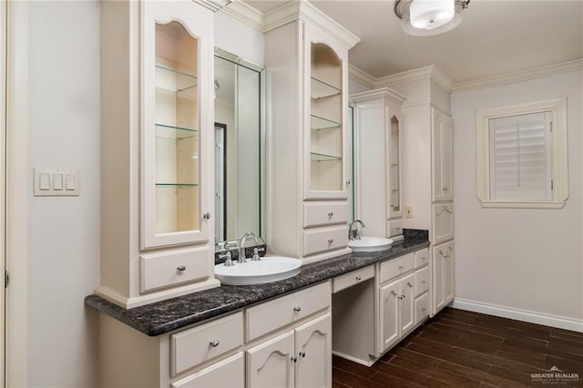 1500 N Bryan Rd, Mission, TX 78572 - bathroom featuring double vanity, wood finished floors, crown molding, and baseboards