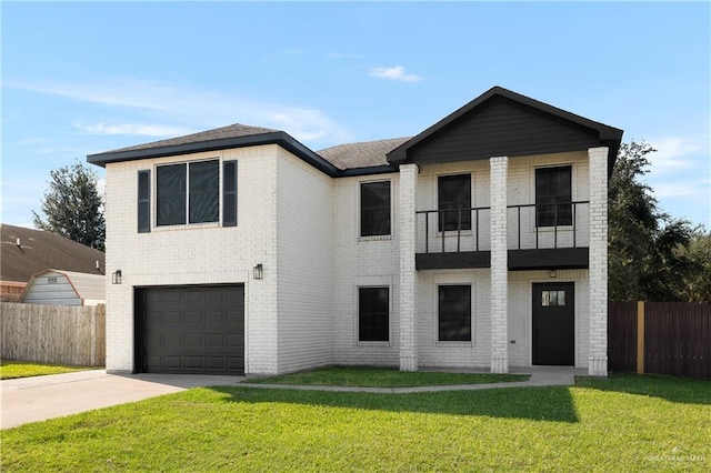 view of front facade featuring a garage, a balcony, and a front yard