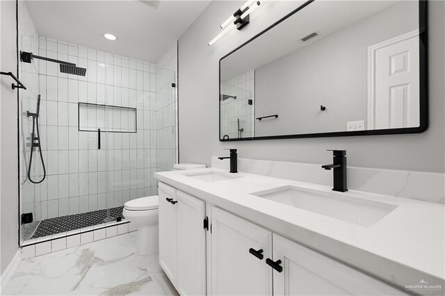 bathroom featuring vanity, toilet, and a shower with shower door