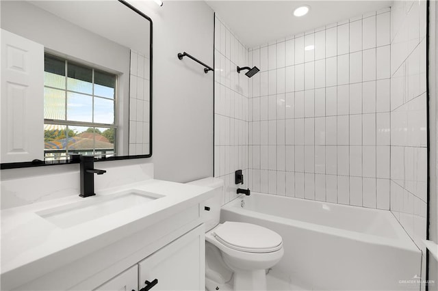 full bathroom featuring toilet, vanity, and tiled shower / bath combo