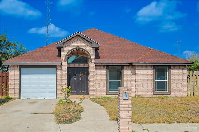 view of front of house with a garage and a front yard