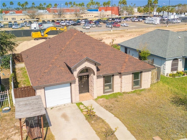 exterior space with a garage and a front lawn