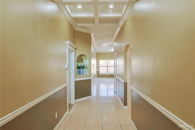 hall featuring beamed ceiling, ornamental molding, coffered ceiling, and light tile patterned floors