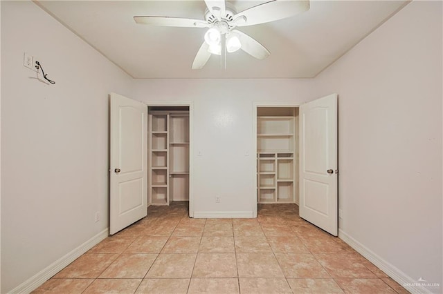 unfurnished bedroom featuring ceiling fan, a spacious closet, and light tile patterned floors