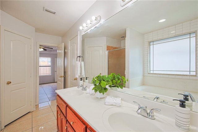 bathroom featuring tile patterned flooring, vanity, and plus walk in shower