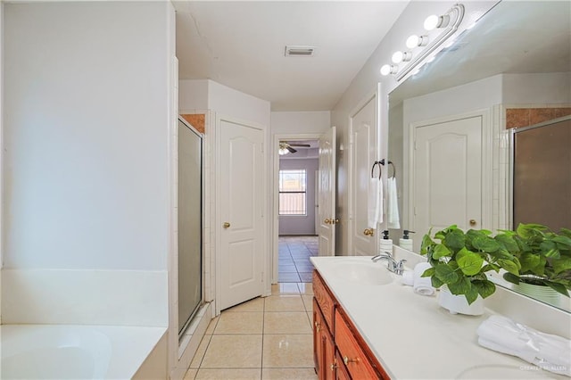 bathroom featuring tile patterned floors, plus walk in shower, and vanity