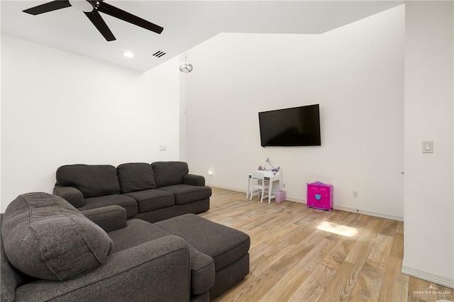 living room with light wood-type flooring and ceiling fan