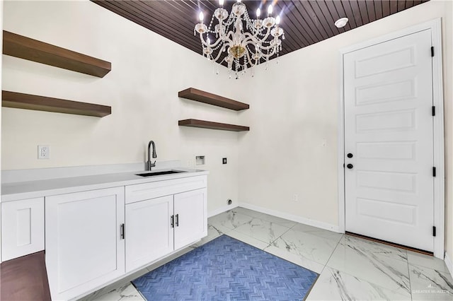 washroom with washer hookup, a notable chandelier, wooden ceiling, and sink