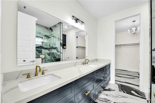 bathroom featuring vanity, a shower with shower door, and a chandelier