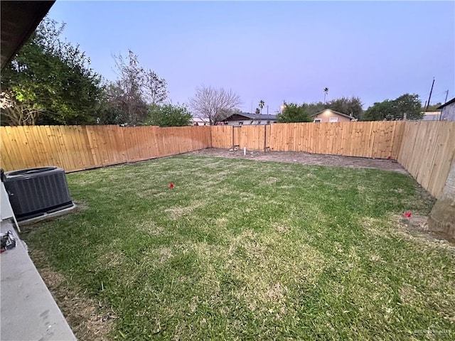 view of yard featuring central air condition unit and a fenced backyard